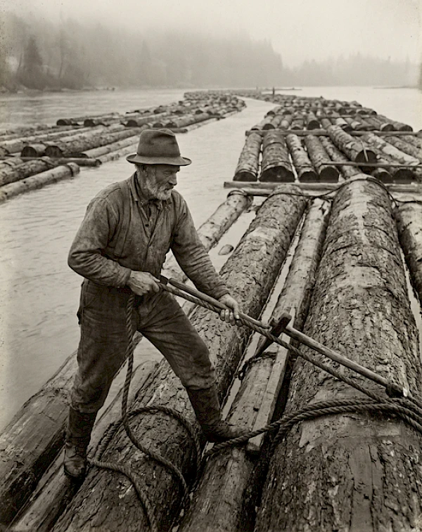 Historická fotografie smíchovských vorařů — muž na voru z dřevěných klád na Vltavě, doba okolo přelomu 19. a 20. století